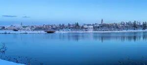 Lakeside Prints: View of the city skyline of Reykjavik from Tjornin lake at sunset in winter