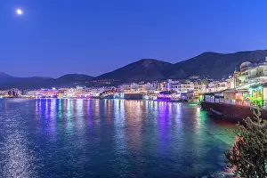 Hotels Prints: View of coastline and beach at dusk with lights reflecting on water in Limenas Chersonisou