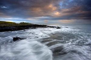 Images Dated 9th November 2009: View along coastline on a stormy day towards the ruins of Dunstanburgh Castle