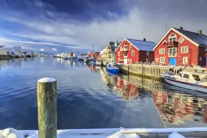 Henningsvaer Prints: View of colorful fishermens houses and private boats overlooking the canal-port of Henningsvaer