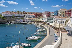 Eateries Prints: View of colourful cafes, restaurants and boats in harbour against blue sky