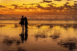 2 People Prints: View of couple at sunset on Kuta Beach, Kuta, Bali, Indonesia, South East Asia, Asia