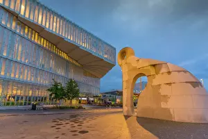 Public Space Prints: View of Creature from Iddefjord statue and Oslo Central Library on cloudy evening
