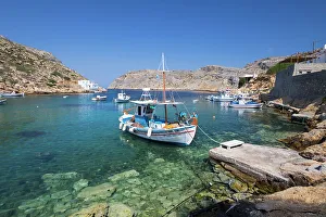View of crystal clear water and fishing boats in harbour, Cheronissos, Sifnos, Cyclades
