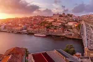 Connections Prints: View of the Dom Luis I bridge over Douro River aligned with colourful buildings at sunset