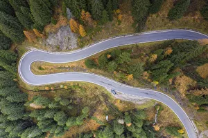 Directly Above Prints: A view by drone of a winding road in the Dolomites, Veneto, Italy, Europe