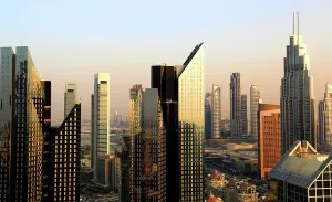 Economy Prints: View of Dubai skyline at night with Burj Khalifa illuminated in evening sky