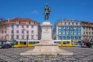 Streetscape Prints: View of Duke of Terceira statue and a modern tram in PC Duque da Terceira on a sunny day