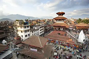 Group Of People Prints: View over Durbar Square from rooftop cafe showing temples and busy streets