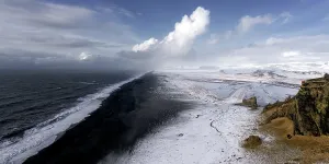Vast Prints: View from DyrhAllaey of the Endless Black Beach after snowfall, winter in Iceland, Europe
