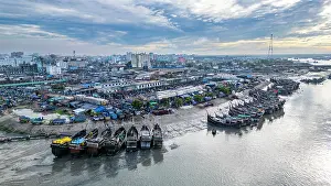 Stalls Prints: View of fish market with boats along the river in Chittagong