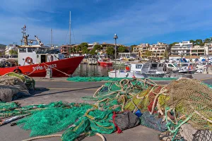 Fishing Nets Prints: View of fishing nets and boats in the harbour at Cala Rajada