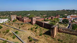 Fortified Prints: View of the fortified city of Silves with ancient walls in Algarve region during daytime