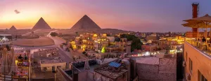 Giza Prints: View of Giza Pyramids from rooftop terrace at dusk, Cairo, Egypt, Africa