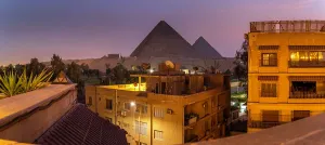 Enchanting Prints: View of the Giza Pyramids from rooftop terrace at dusk, Giza, Cairo, Egypt, Africa