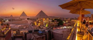 Terrace Prints: View of Giza Pyramids from rooftop terrace at dusk, Cairo, Egypt, Africa