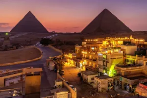 Terrace Prints: View of Giza Pyramids from rooftop terrace at dusk, Cairo, Egypt, Africa