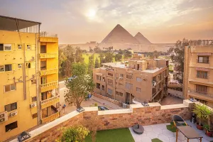 Giza Prints: View of the Giza Pyramids from rooftop terrace during golden hour