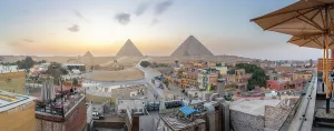 Giza Prints: View of Giza Pyramids from rooftop terrace at sunset, Cairo, Egypt, Africa