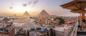 Enchanting Prints: View of Giza Pyramids from rooftop terrace at sunset, Cairo, Egypt, Africa