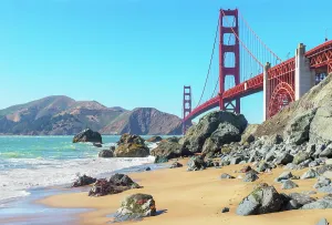 Enjoyment Prints: View of Golden Gate Bridge from Bakery Beach in San Francisco with rocks and waves during daytime