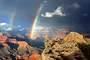 Grand Prints: View of the Grand Canyon with rainbows appearing over the rock formations during afternoon light in Arizona