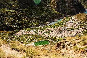 Spaces Prints: View of Guejar Sierra village near the blue waters of Guejar Embalse lake in Spain's Sierra Nevada region