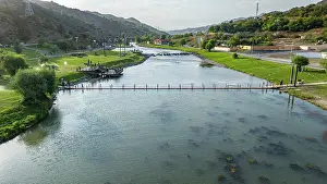 Flowing Prints: View of Hakari river flowing through mountain resort in Qarabaqh region of Azerbaijan under clear skies
