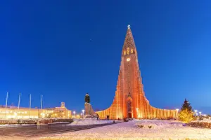 Popular Prints: View of Hallgrimskirkja church illuminated at dusk in winter, Reykjavik, Iceland