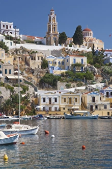 View over harbour to colourful houses and church, Gialos (Yialos), Symi (Simi), Rhodes