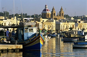Marsaxlokk Prints: View across harbour with traditional Luzzu fishing boats, Marsaxlokk, Malta