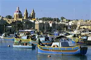 Images Dated 8th December 2011: View across harbour with traditional Luzzu fishing boats, Marsaxlokk, Malta