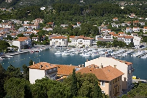 View from hillside across colourful tiled rooftops to the harbour, Rab Town