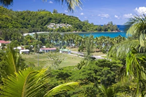 Images Dated 1st May 2009: View from hillside across playing field to village and bay, Baie Lazare