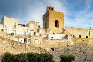 Charm Prints: View of historic buildings and clock tower in Otranto during sunset in Puglia region Italy
