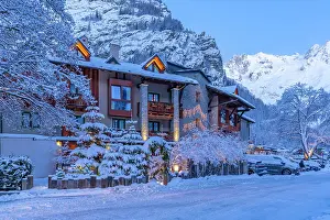 Chalets Prints: View of hotel and snow covered mountains in Courmayeur before dawn in winter