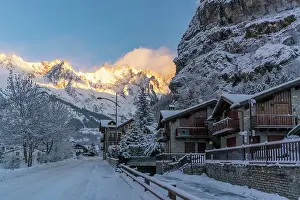 Chalets Prints: View of hotels, chalets and snow covered mountains in Courmayeur at sunrise in winter
