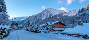 Cabin Prints: View of hotels, chalets and snow covered mountains in Courmayeur at sunrise in winter