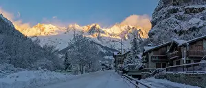 Chalets Prints: View of hotels, chalets and snow covered mountains in Courmayeur at sunrise in winter