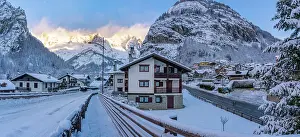 Chalets Prints: View of hotels, chalets and snow covered mountains in Courmayeur at sunrise in winter