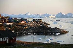 A view over houses and the Ilulissat Kangerlua Glacier also known as Sermeq Kujalleq