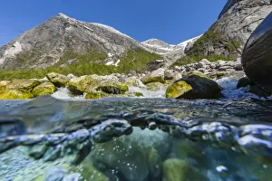Above and below view of ice melt waterfall cascading down in Svartisen National Park, Melfjord, Nordfjord, Norway, Scandinavia, Europe