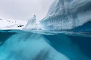 Antarctica Prints: Above and below view of an iceberg at Cuverville Island, Ererra Channel, Antarctica