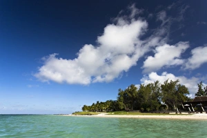 View of idyllic Belle Mare Beach showing blue sky, soft sand and the aquamarine sea of the Indian Ocean, near Centre De Flacq on the east coast of Mauritius, Indian Ocean, Africa