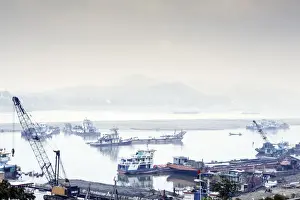 Crane Prints: View of industrial boats on the Ayeyarwady River (Irrawaddy) river