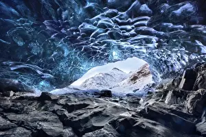 Glacier Prints: View from inside ice cave under the Vatnajokull Glacier towards snow covered mountains