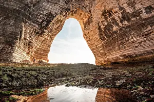 Archway Prints: View from inside a sea cave in Normandy looking toward the sky through a chalk arch with weathered rock formations