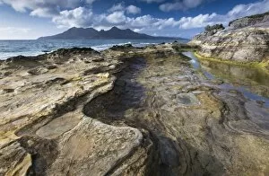 View towards Isle of Rum from rock formations at Laig Bay, Isle of Eigg