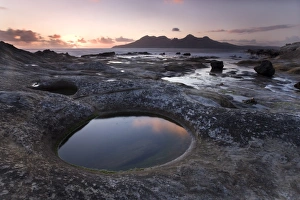 Images Dated 6th November 2008: View towards Isle of Rum at sunset from rock formation at Laig Bay, Isle of Eigg