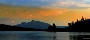 Ripples Prints: View of Jack Lake with Rocky Mountains under sunset sky near Banff in Canada